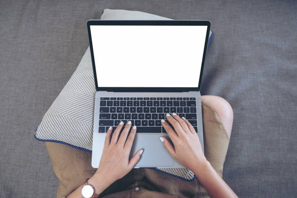 istock a woman using and typing on laptop keyboard with blank white screen while sitting in living room 1140303372