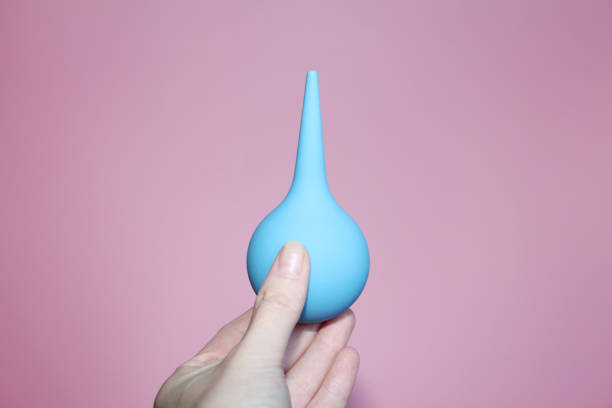 istock Blue syringe with a soft tip in a female hand. 1140305685