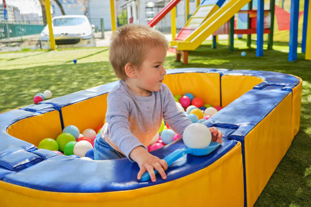 istock Kid in ball pit having fun in children play center 1140306015