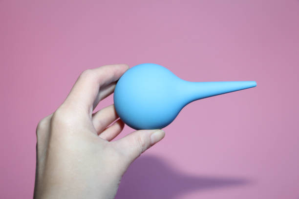istock Blue syringe with a soft tip in a female hand. 1140306044
