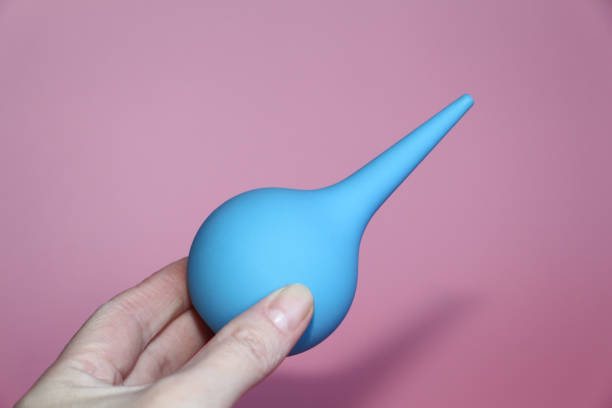 istock Blue syringe with a soft tip in a female hand. 1140306155