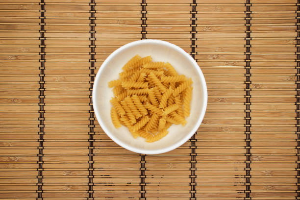 istock Pasta in white dish on wooden background 1140308989