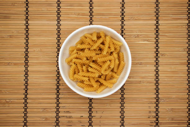 istock Pasta in white dish on wooden background 1140309067