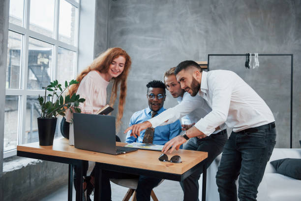 istock Such an incredible results. Group of multiracial office workers in formal clothes talking about tasks and plans 1140309523