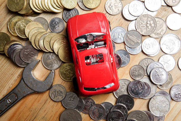 istock Directly Above Toy Car Surrounded By Coins On Table 1140309678