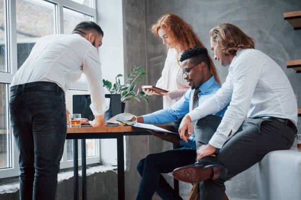 istock Discussing project. Group of multiracial office workers in formal clothes talking about tasks and plans 1140310386