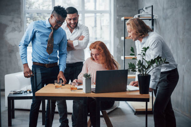 istock Corporate nuances. Young business team working on a project with laptop on table and smiling 1140311343