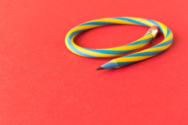 istock Flexible pencil . Isolated on red background. Bending pencil. 1140312393