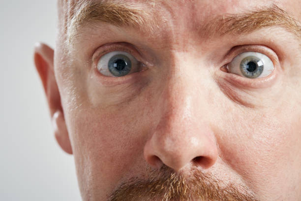 istock Wide-eyed mature man with raised eyebrows looks shocked, scared 1140322993