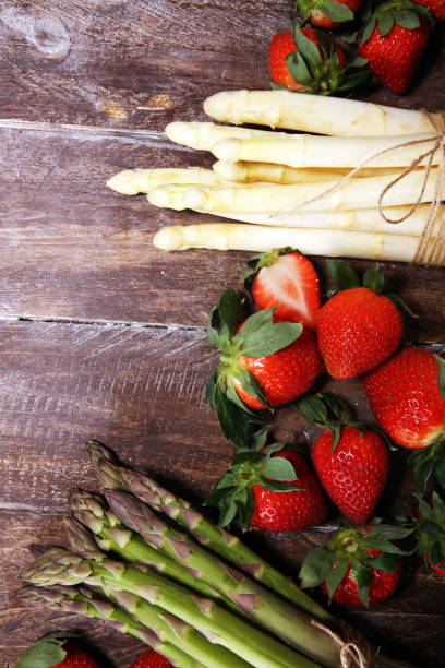 istock White and green asparagus with strawberries on wood 1140323608