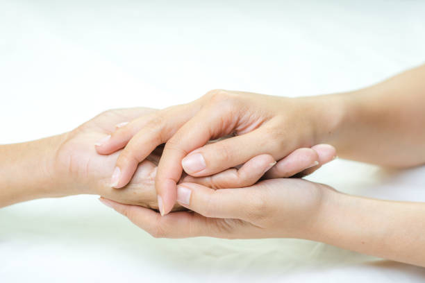 Asian senior and asian young holding hands.
