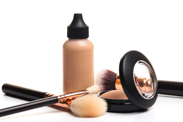 istock Liquid makeup foundation cream and  shadow, blush, powder, sculptor in a pack with make up brushes on a white background. Isolated on white. - Image 1140325473