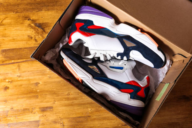 istock new sneakers in the box on wooden background- Image 1140325647
