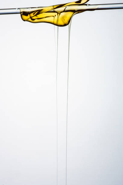 istock Pouring honey or golden liquid on white background. 1140325954