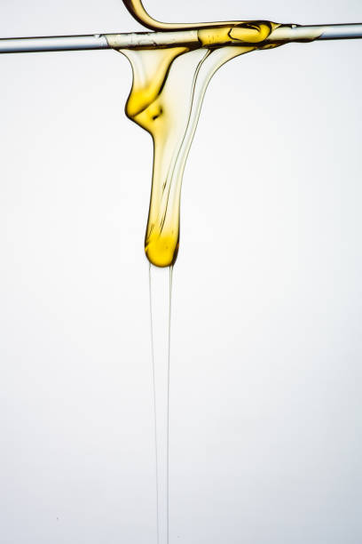 istock Pouring honey or golden liquid on white background. 1140325959