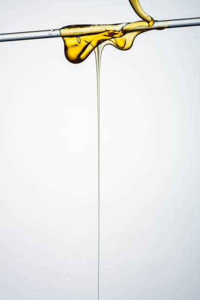 istock Pouring honey or golden liquid on white background. 1140325972