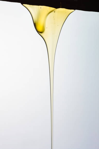 istock Pouring honey or golden liquid on white background. 1140326003