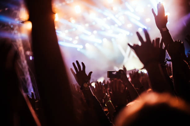 istock Cheering crowd at concert enjoying music performance 1140328174