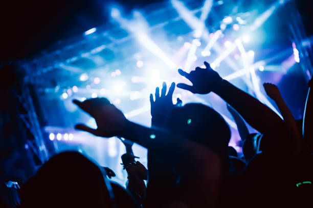 istock Cheering crowd at concert enjoying music performance 1140328195