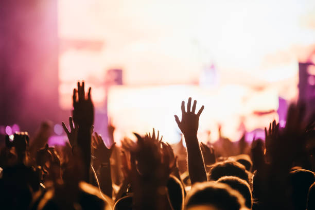 istock Cheering crowd at concert enjoying music performance 1140328199