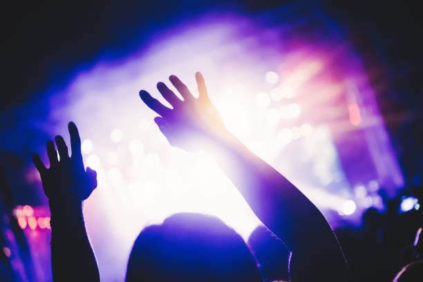 istock Cheering crowd at concert enjoying music performance 1140328237