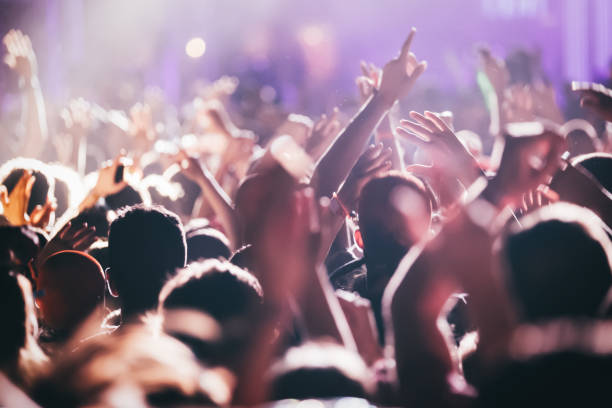 istock Cheering crowd at concert enjoying music performance 1140328280