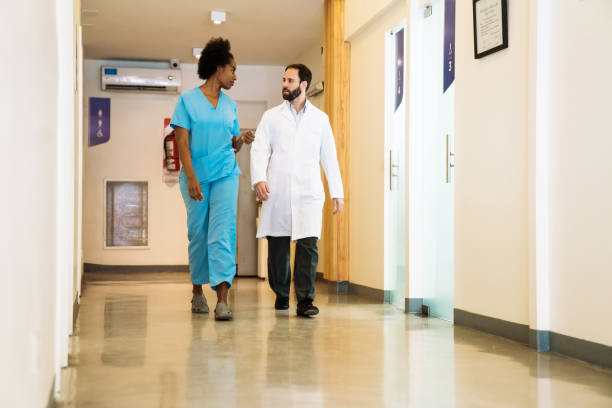 istock Healthcare workers walking in corridor 1140328283
