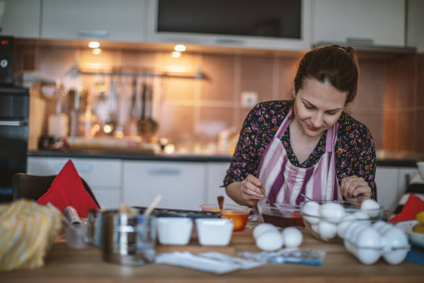 istock Woman painting Easter eggs 1140328473