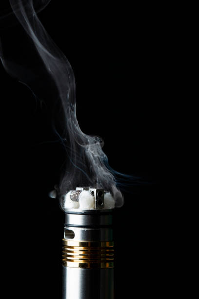 istock electronic cigarette and smoke in the black background 1140331429