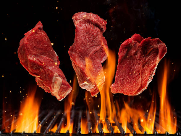 istock Flying raw beef steaks above burning grill grid 1140334101