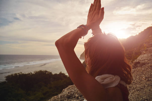 istock Young woman practicing yoga - meditation on the beach. 1140336005