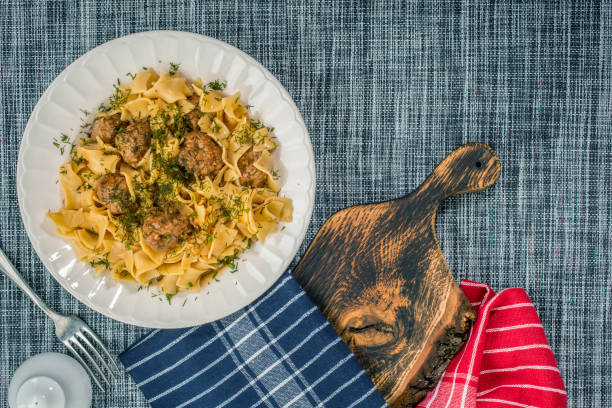 istock Tagliatelle pasta with pork meatballs and dill sauce. Selective focus. 1140336269