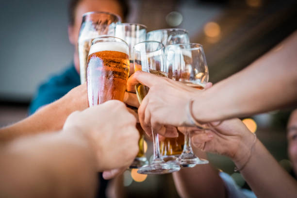 istock Hands of friends toasting drinks during party 1140337309