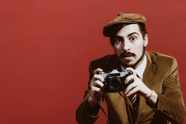 istock very positive photographer posing in studio with film camera 1140337740