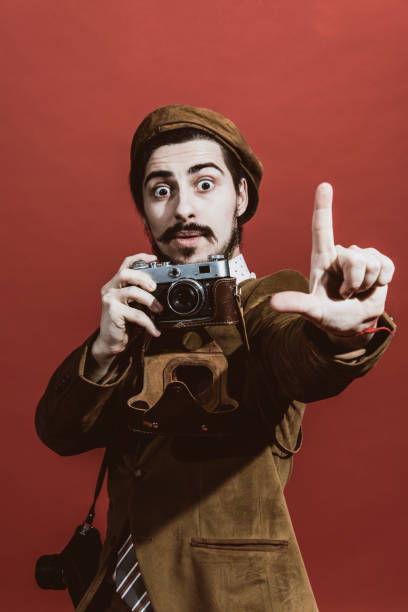 istock very positive photographer posing in studio with film camera 1140337830