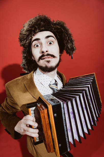 istock a very positive man with an accordion posing in the studio 1140337880