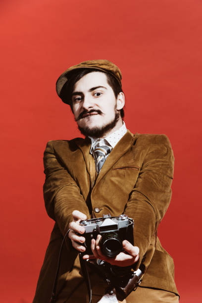istock very positive photographer posing in studio with film camera 1140338617