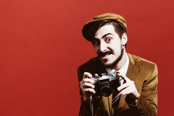 istock very positive photographer posing in studio with film camera 1140338815