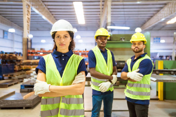 istock Confident female worker standing ahead of team 1140342244