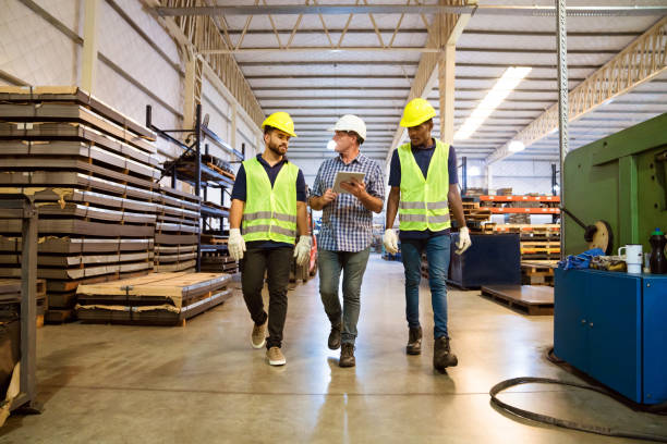istock Foreman discussing with trainees in factory 1140342479