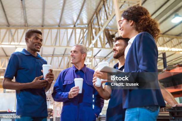 Manager Taking Break With Engineers In Warehouse Stock Photo - Download Image Now - Factory, Disposable Cup, Drink