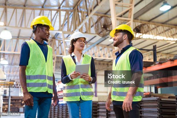 Manager With Digital Tablet Talking To Workers Stock Photo - Download Image Now - 20-24 Years, 25-29 Years, 30-34 Years