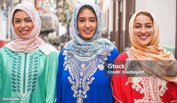 Portrait Of Arabian Girls Outdoor In City Street Young Islamic Women Smiling On Camera Youth Friendship Religion And Culture Concept Focus On Faces Stock Photo - Download Image Now