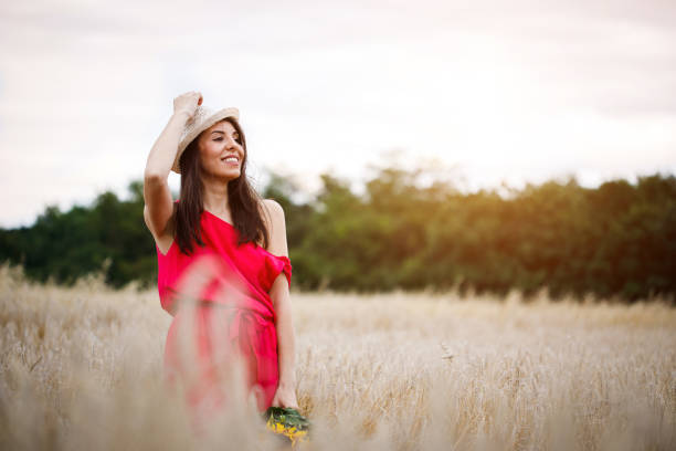 istock Beautiful girl in a wheat field 1140346466