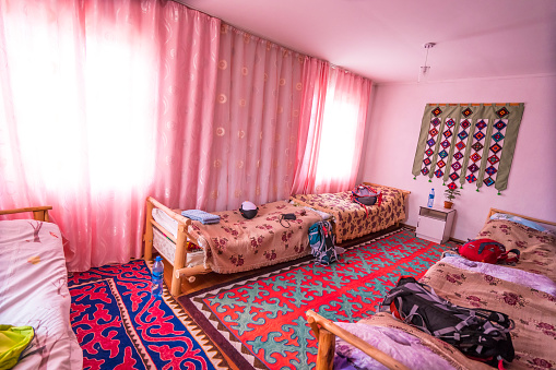 Traditional room with beds for tourists in suburb of small town Bokonbayevo, which is located in the Southern shore of lake Issyk-Kul. Kyrgyzstan.