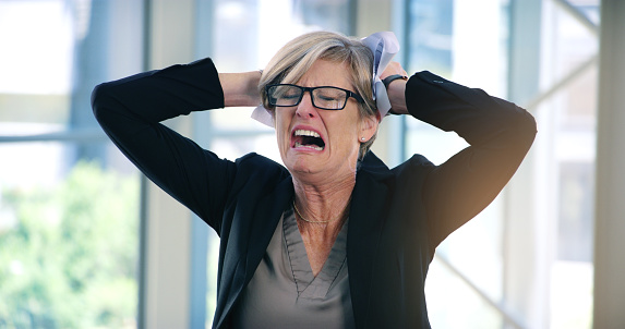 Shot of a mature businesswoman looking stressed out in an office