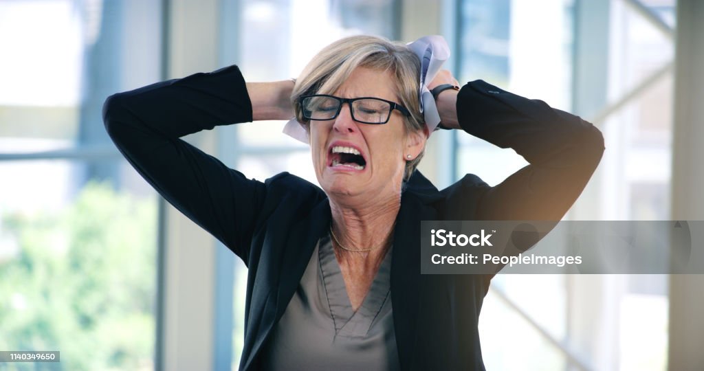 I don't see an end to this challenge Shot of a mature businesswoman looking stressed out in an office Terrified Stock Photo
