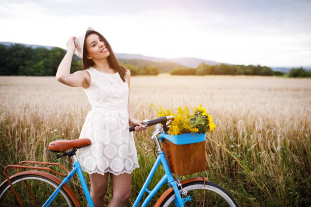 istock Woman with bicycle on wheat field. 1140349767