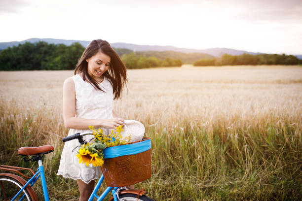istock Woman with bicycle on wheat field. 1140350484