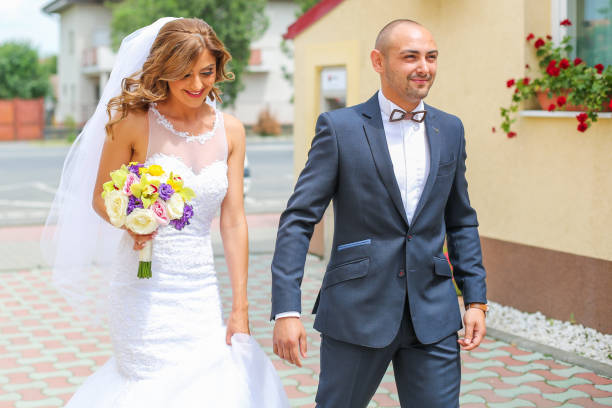 Handsome wedding couple posing on street